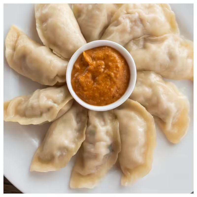 Chicken Steam Momo — 8 pieces with orange chutney